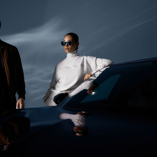 Shows Picture of man-and-woman-standing-neyt-to-porsche-car-wearing-porsche-design-fashion.jpg