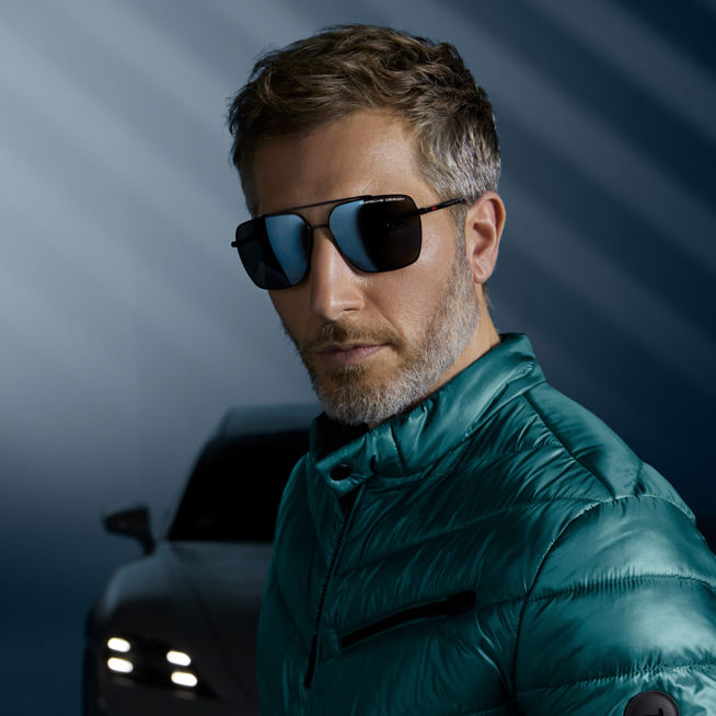 Shows Picture of man-wearing-winter-jacket-and-porsche-design-eyewear-porsche-in-back.jpg