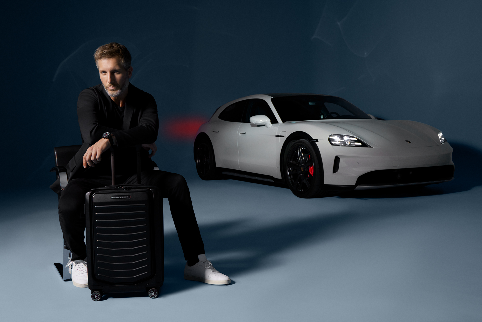 Shows Picture of man-sitting-with-trolley-porsche-in-back.jpg