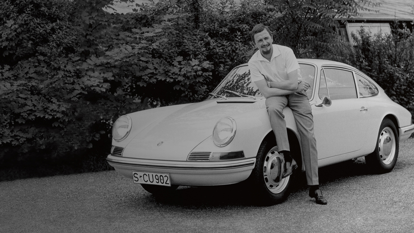 PROFESSOR FERDINAND ALEXANDER PORSCHE sitting on an old Porsche