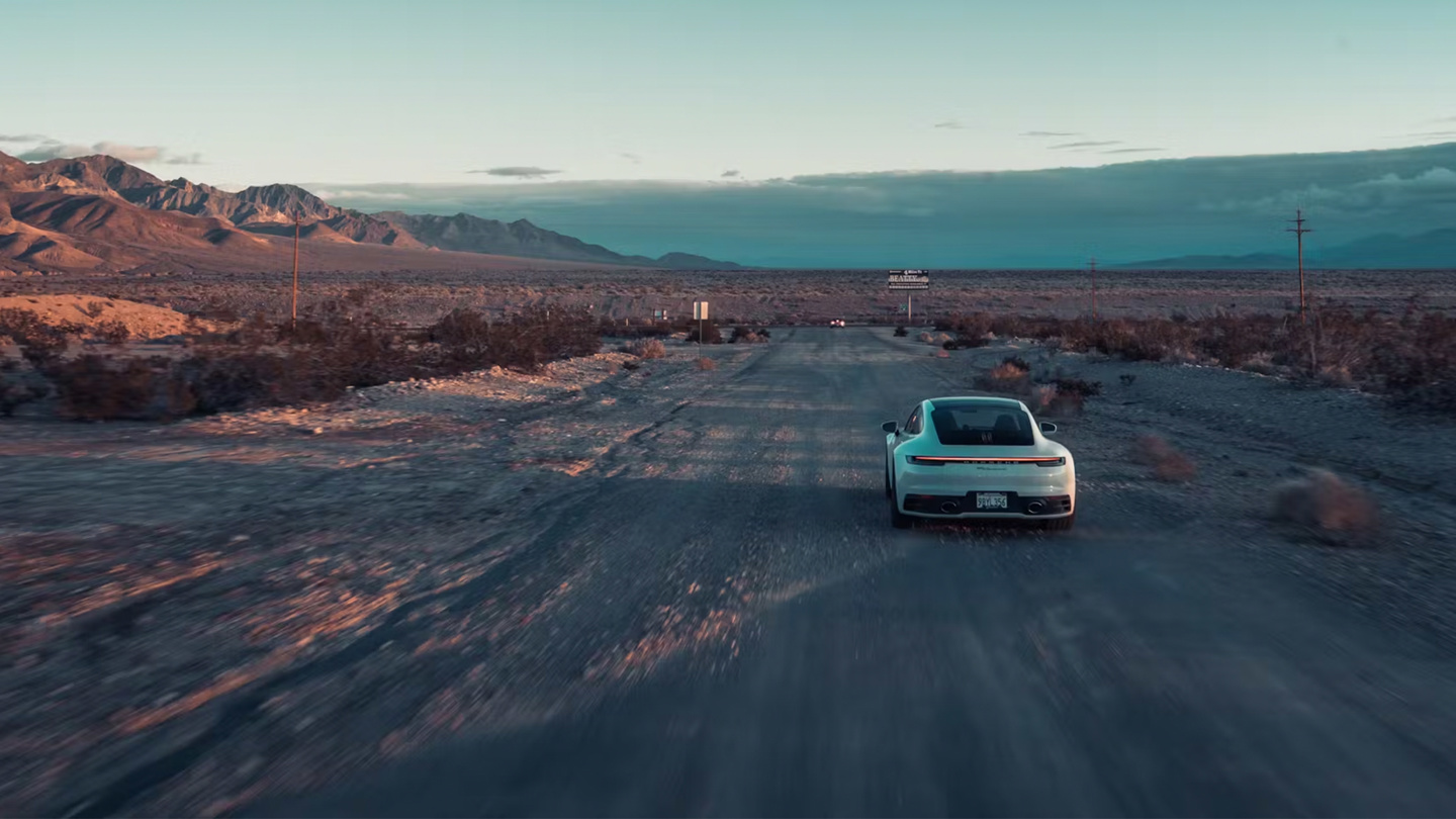 Shows Picture of A_white_Porsche_911_in_the_landscape.jpg